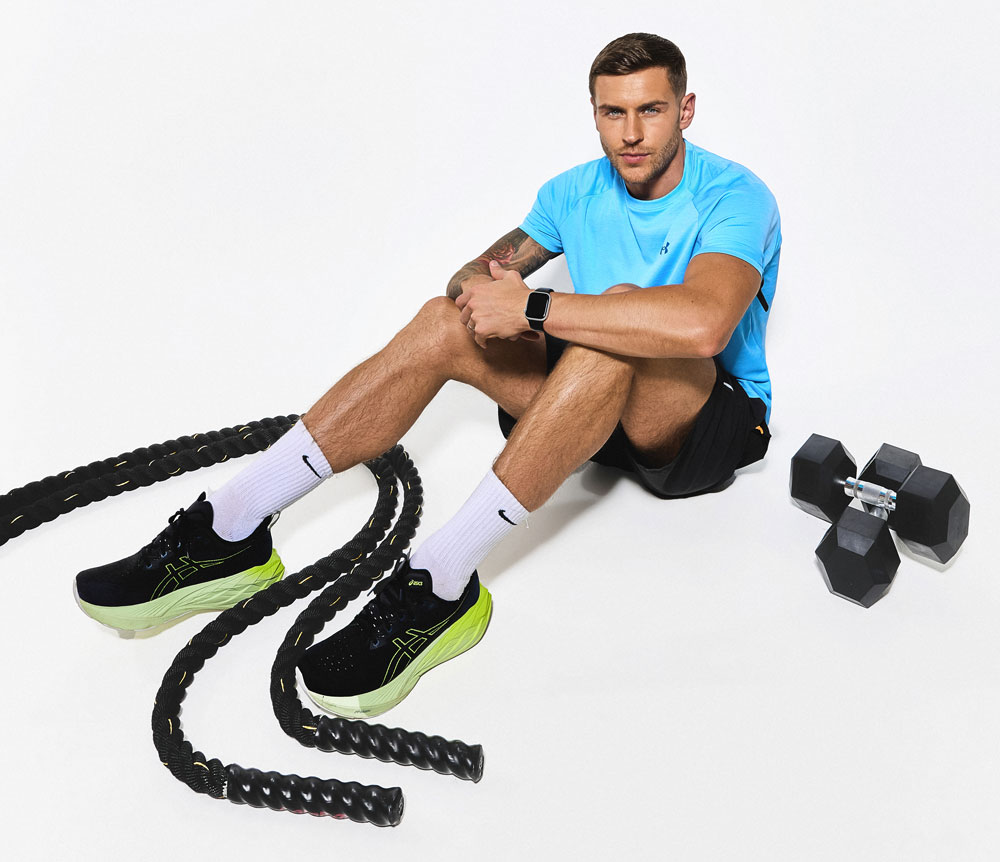 The coach is posing while sitting.