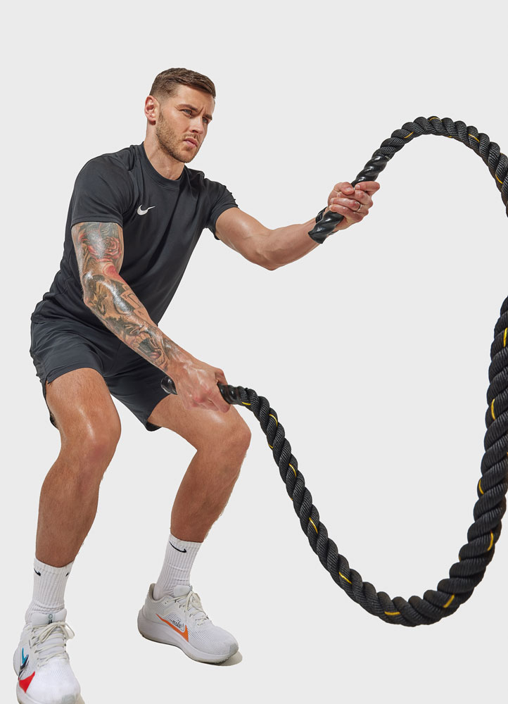 The coach is holding the rope.