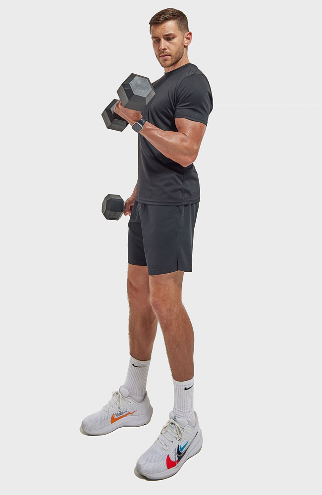 The coach is holding the dumbbells.